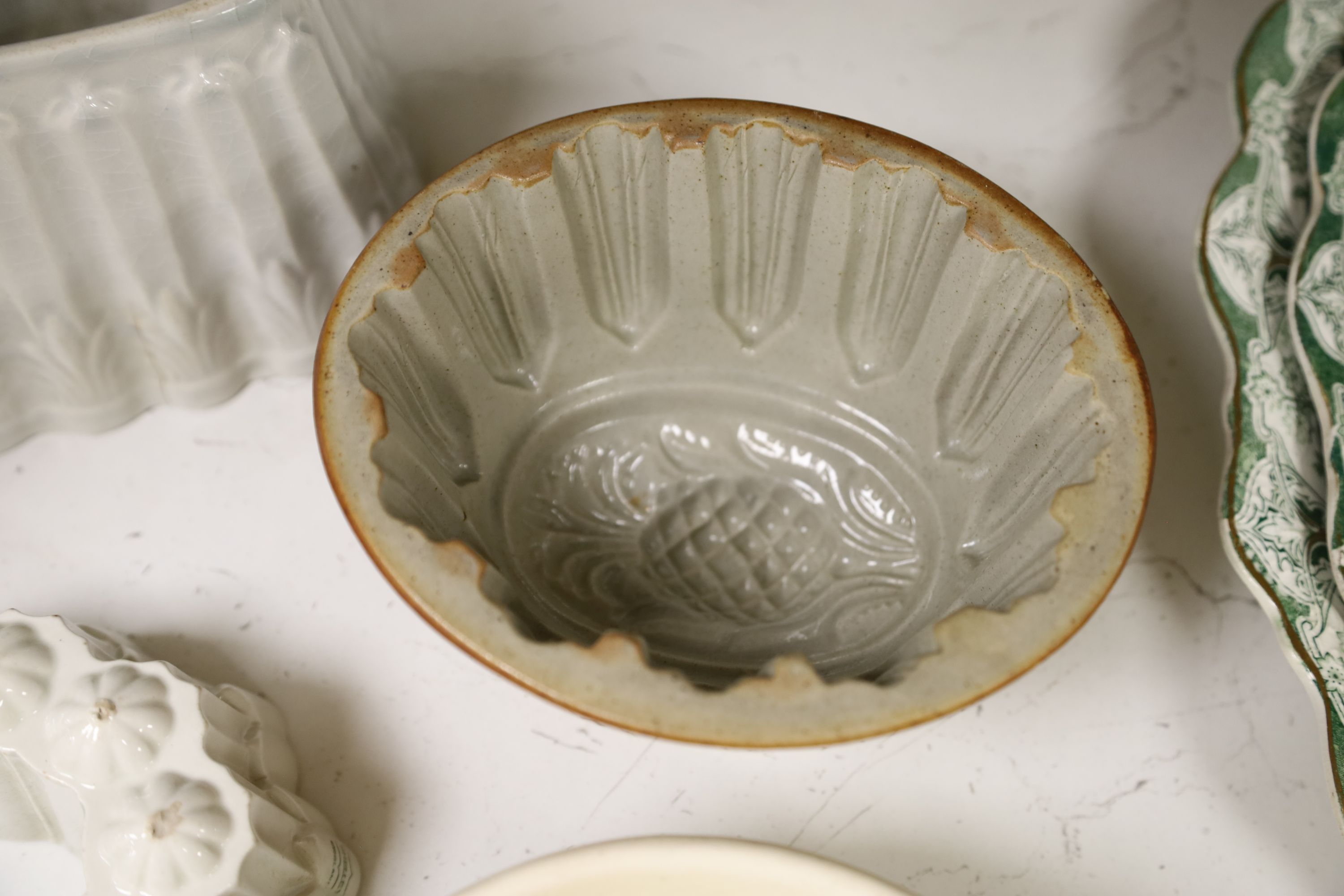 Six pottery jelly moulds including one Shelley